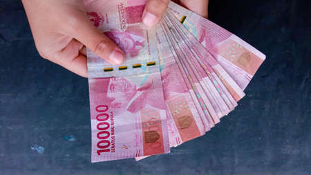 Photo of the red 100 thousand currency, the Indonesian state currencyの写真素材