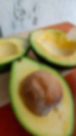 Blur photo of avocado on wooden table backgroundの写真素材
