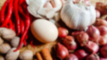 Blur photo of cooking ingredients, chili, chicken eggs, red chili and garlicの写真素材