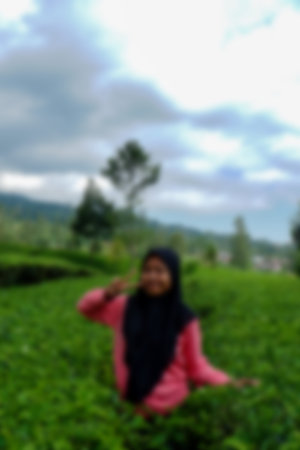 Blur photo of asian couple on vacation in tea garden
