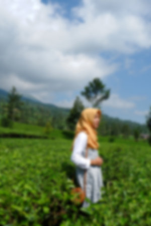 Blur photo of asian couple on vacation in tea garden