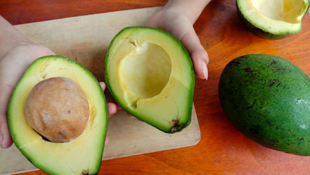 A photo of an avocado that has been split on a tableの写真素材