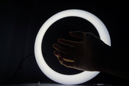 Neon light circle in black hall room, futuristic concept, abstract geometric background, product display.Beautiful colorful light effect of neon glow lights and flashの写真素材