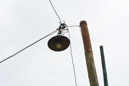 Low angle photo of an electric pole on the side of the road. With a clear sky view. No peopleの写真素材