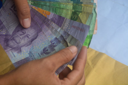 looks at the means of payment in Indonesia. Indonesian money is called rupiah. used as legal tender. not only to buy, money can also be used as a gift from other people.の写真素材
