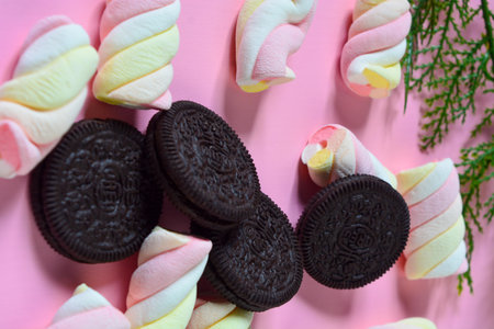May 2, 2023, Oreos, Vertical photo of sweet chocolate chip cookies and marshmallows on a pink...
