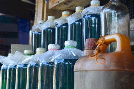 Gasoline sold in retail uses liter bottles.の写真素材