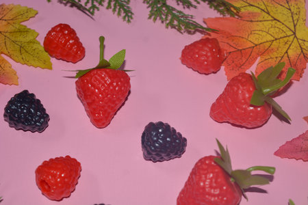 Isolated Blueberry, Blackberry and Strawberry fruit. Against a pink background