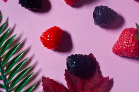 Isolated Blueberry, Blackberry and Strawberry fruit. Against a pink backgroundの写真素材