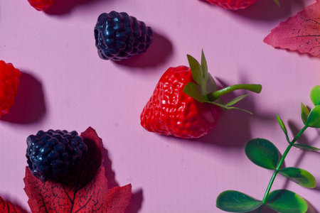 Isolated Blueberry, Blackberry and Strawberry fruit. Against a pink background