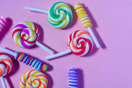Flat lay sweet candy favorite of small children. Colorful lollipops, candies, chocolates. Pink...