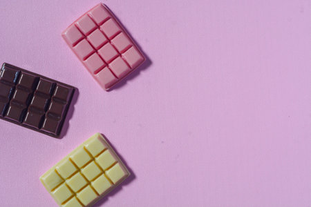 Flat lay sweet candy favorite of small children. Colorful lollipops, candies. Pink background