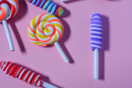 Flat lay sweet candy favorite of small children. Colorful lollipops, candies, chocolates. Pink...