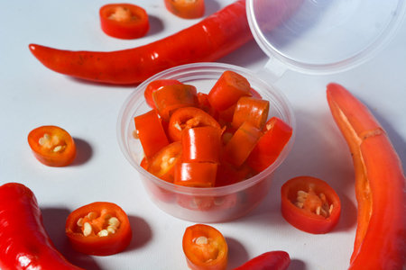 Scene of the red chili which looks very hot against a white background. No people.