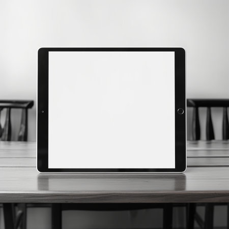 Tablet computer with blank screen on wooden table in cafe. Mock upの素材