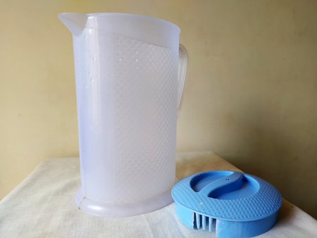 A plastic jug with blue cover used for storing water and other liquids is placed overの写真素材
