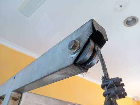 Steel pulley and frayed cable used in gym equipmentの写真素材