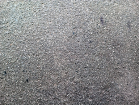 Close up view of uneven cement surface showing natural rough patterns and texture detailsの写真素材