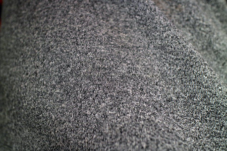 Close up of a textured gray fabric, showcasing a soft and cozy appearance, ideal for clothing or interior design.の写真素材