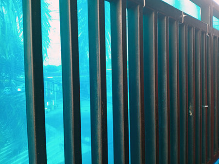 Close up of metal bars against a blue background, creating a pattern.の写真素材