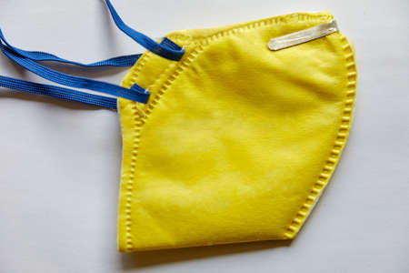 Yellow N95 Mask isolated on a white backgroundの写真素材