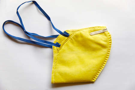 Yellow N95 Mask on white background (isolated)- Leak proof, has Micro fine fibers and with electrostatic charge gives max filtering efficiency, filters more than 95% non-oil based particlesの写真素材
