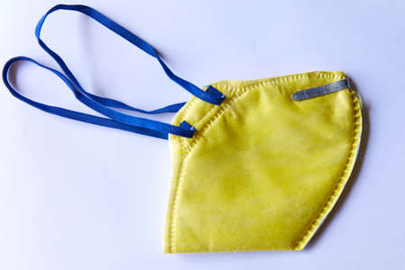 Yellow N95 Mask on a white backgroundの写真素材