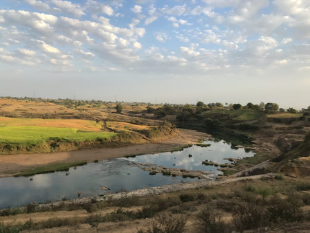 Landscape with river and forest in cloudy days - A view of Narmada River taken from Train window