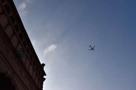 Jet plane aircraft travelling in the sky over city building in Bhopal, Madhya Pradesh/Indiaの写真素材