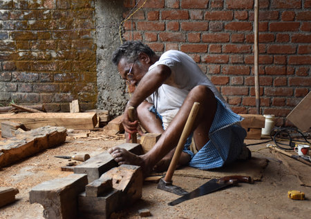 Narsinghpur, Madhya Pradesh/India : June 22, 2020 - A carpenter working on wood by using traditional toolsのeditorial素材