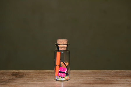 Small glass vial with I love you message, teddy and love card