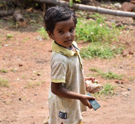 Karakbel, Madhya Pradesh/India : September 8, 2020 - Poor little girl holding toys in her handsのeditorial素材