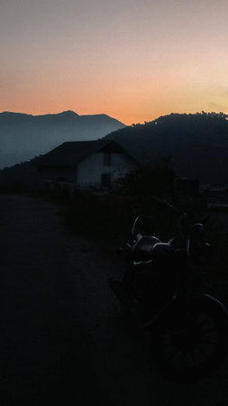 Vintage grainy shot of a motorcycle in the mountains during sunset
