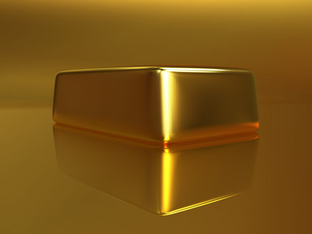 Isolated gold bullion on a yellow background with a reflectionの写真素材
