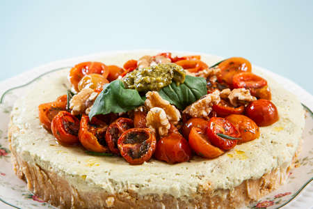 close-up of pesto cheesecake prepared to eat and presented in the center of the tableの写真素材