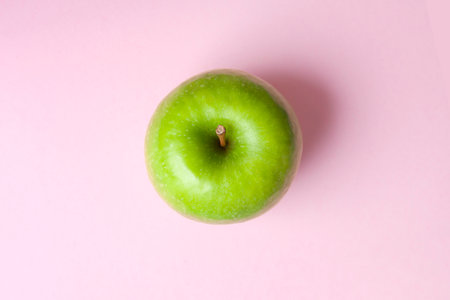 top view whole isolated granny smith green apple on pink background horizontalの写真素材