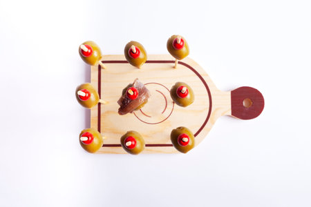 top view of olives on skewers with white background