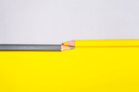 yellow and gray pencil on a background of the same inverted color. Concept geometric office or school background.の写真素材