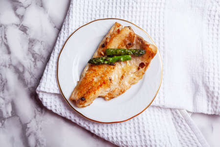 Top view of sea bass fillet with asparagusの写真素材