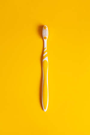 Yellow toothbrush on yellow background. Copy space.の写真素材
