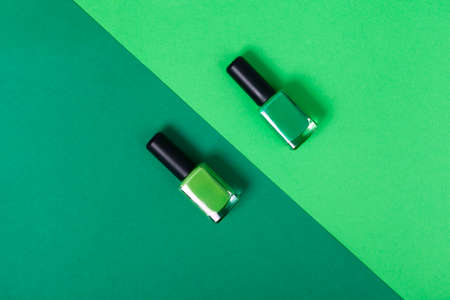 top view green nail polish 2 shades with background of the same colorの写真素材