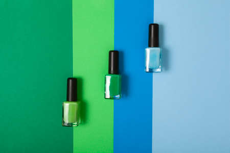 top view green and blue nail polish various shades with background of the same colorの写真素材