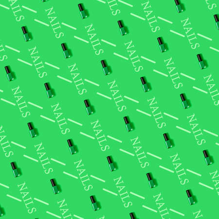 Pattern of green nail polish with green background and the written word "nails"の写真素材