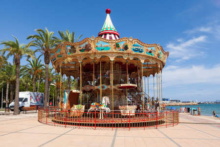 Spain. August 03, 2021. Cambrils: vintage carousel in the middle of the promenadeのeditorial素材