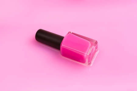 Close up pink nail polish on a background of the same color with advertising space. Aesthetics concept.の写真素材
