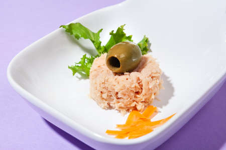 front view close up of tuna snack with olive and purple backgroundの写真素材