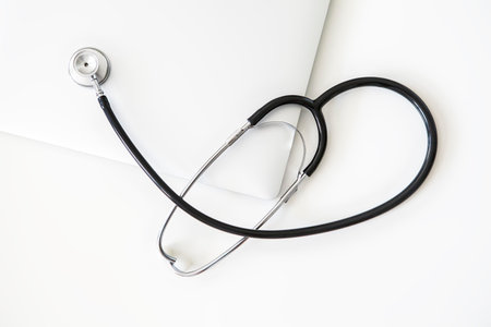 top view of stethoscope on laptop with white background