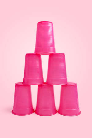 stacking game with pink stacked cups and pink backgroundの写真素材