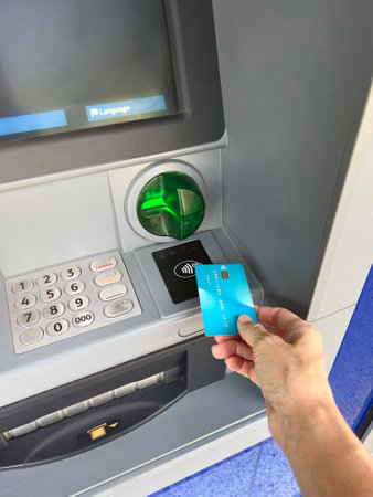 Contactless withdrawal from an ATM by credit card, finance conceptの写真素材