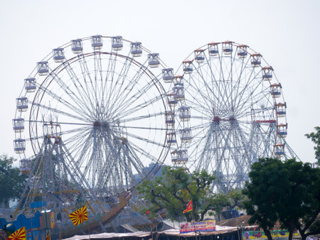 Pushkar, Rajasthan / India - November 5, 2019 : Indiaâs biggest cattle and culture fair âpushkar camel fairâ, village people visiting stalls, shopping and enjoy riding on Ferris whのeditorial素材